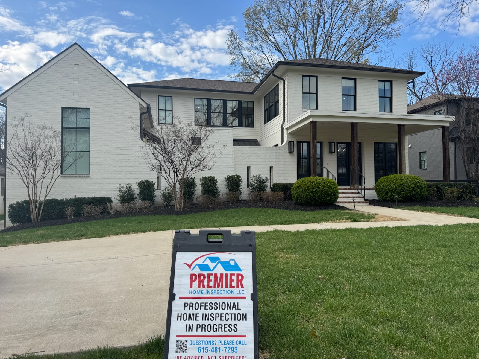 Home inspection sign in front of potential home for a client.