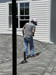 Home inspector walks the roof line of a client's potential home.